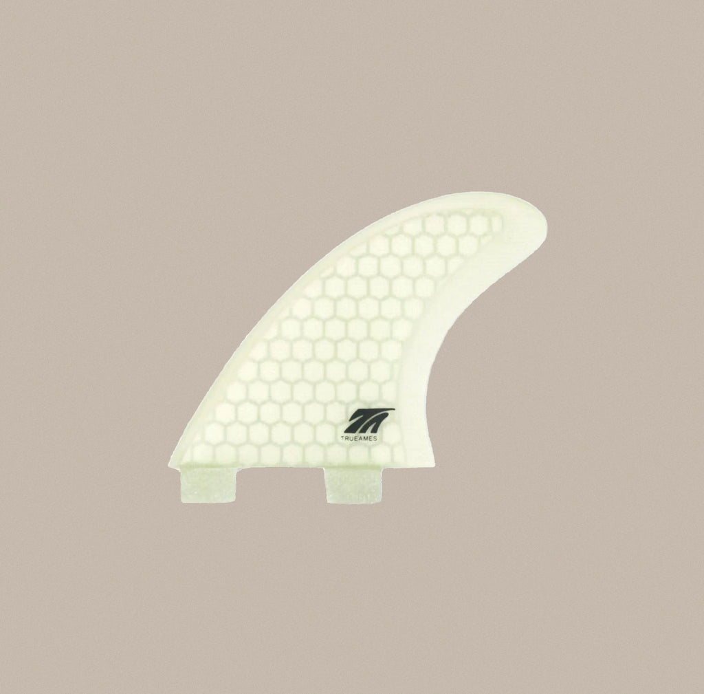 A True Ames 4" Side Bite FCS fin in clear hexcore.