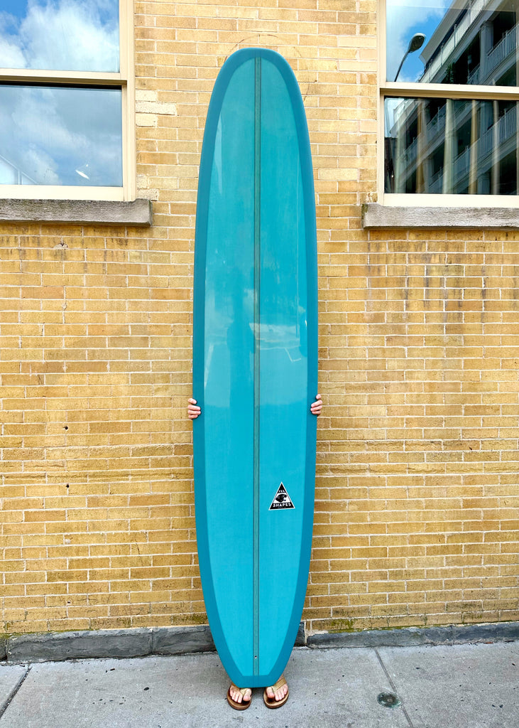 A Yee Shapes 9'5" teal Blunt Nose Log Surfboard for sale