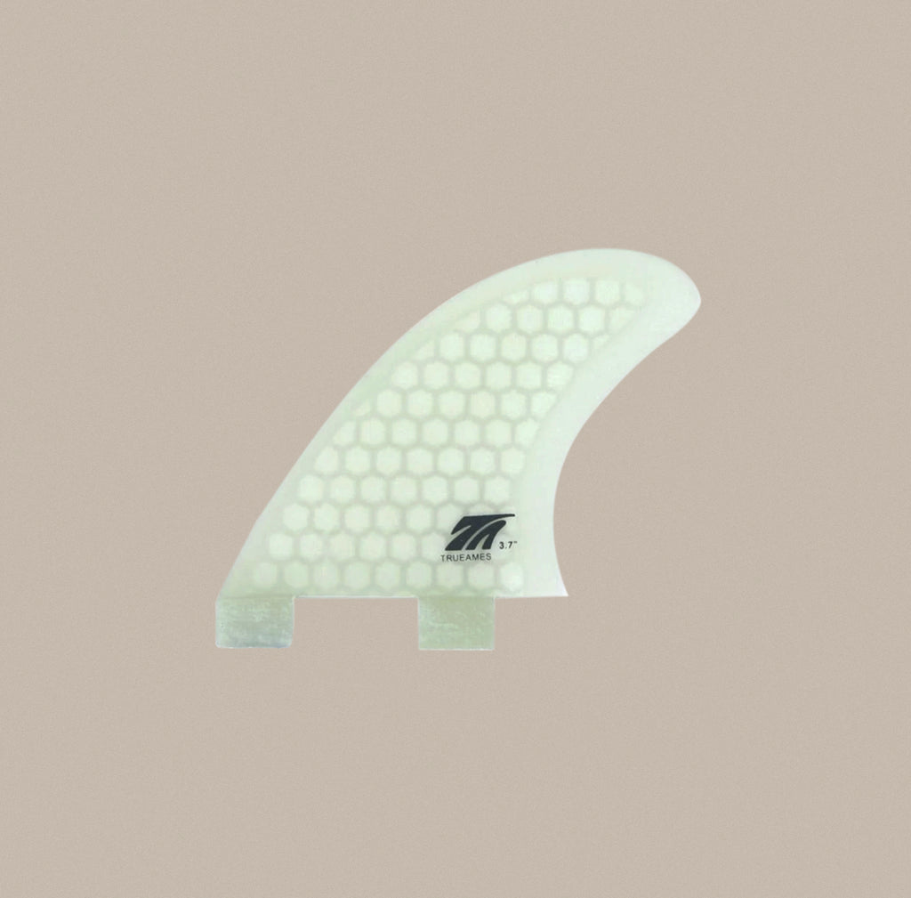 A True Ames 3.7" Side Bite FCS fin in clear hexcore.