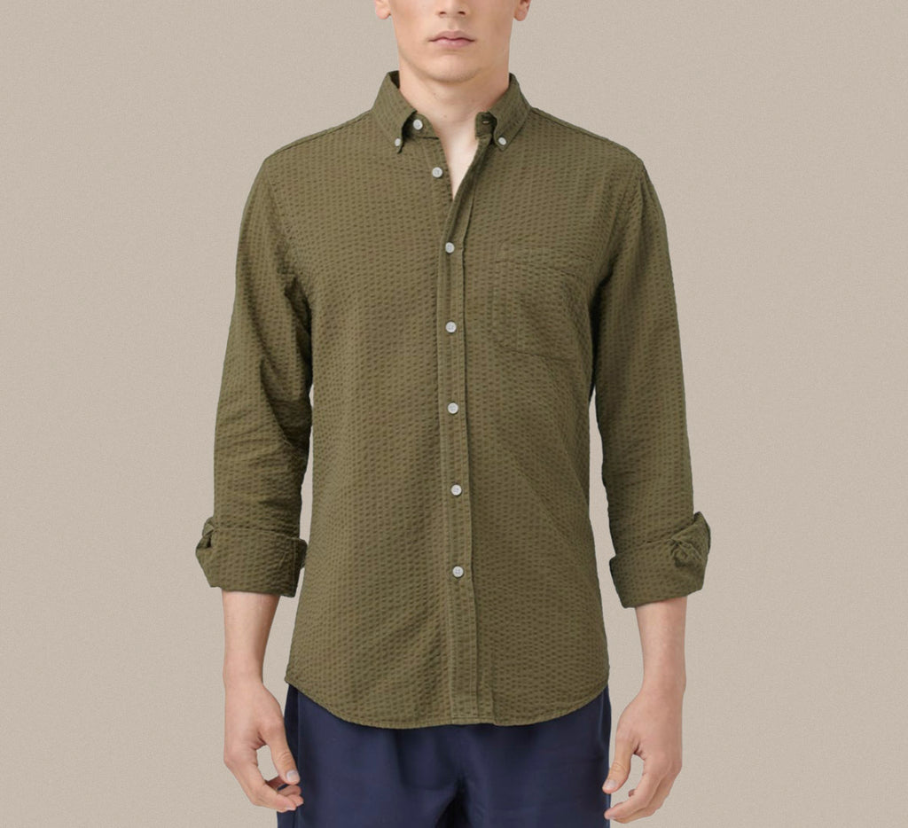 A cotton seersucker olive green button down shirt from Portuguese Flannel.