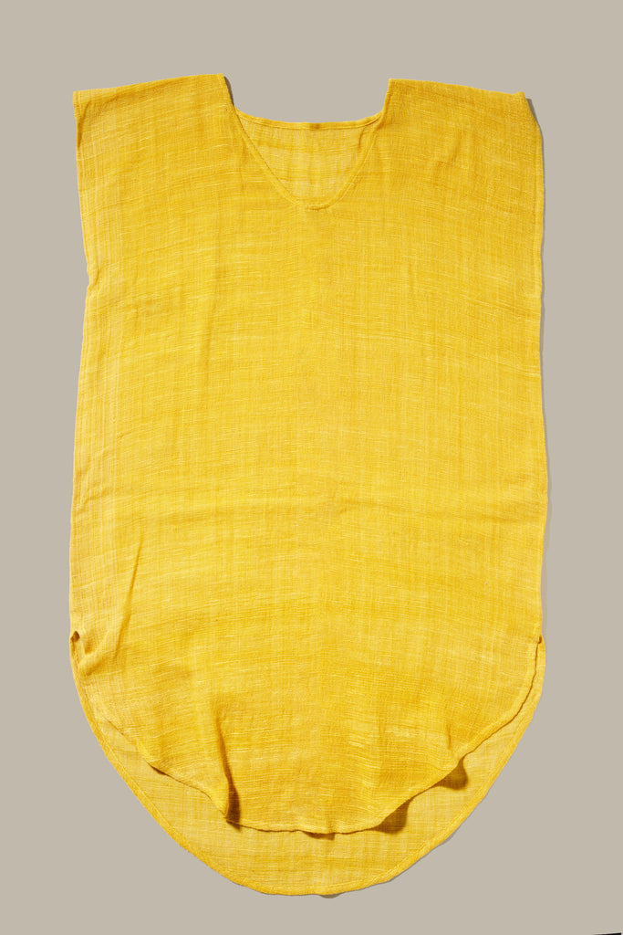 The Khadi Oaxaca Dress in mustard has a boxy fit, lightweight weave, and rounded hem.