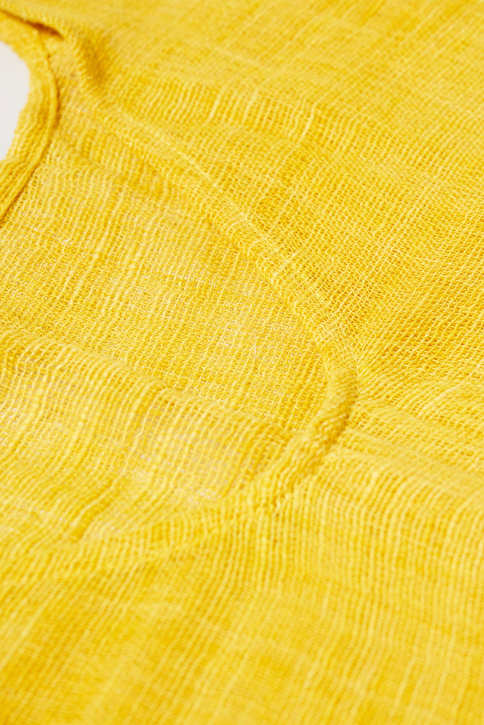 Close up detail of the cotton weave on the Khadi Oaxaca Dress in Mustard.